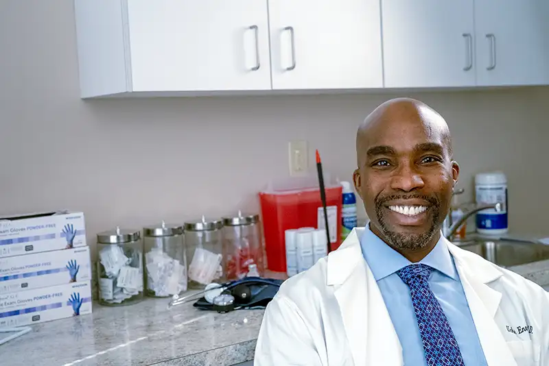 Dr. Uche Eneanya, pain management specialist, standing in treatment room at New Jersey clinic