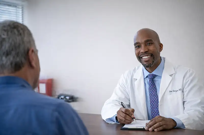 Pain management physician speaking with patient during consultation in New Jersey clinic