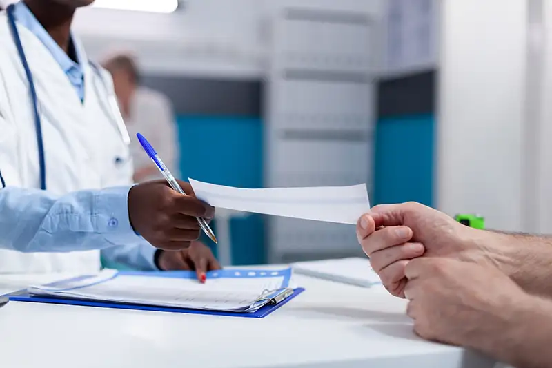 Doctor reviewing insurance paperwork with patient at pain management clinic in New Jersey