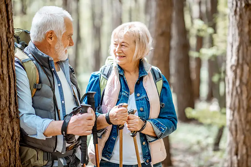 Older couple hiking outdoors after recovery from orthopedic surgery