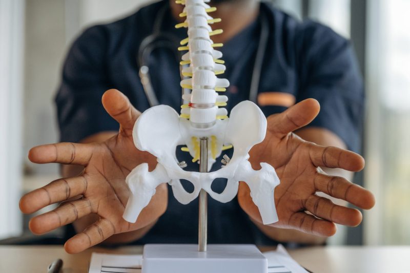 Pain management specialist discussing the location of sacroiliac joint pain with a patient